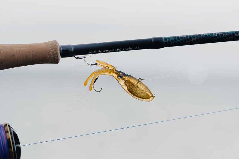 Nomad Design Squidtrex Patented Vibrating Fishing Lure- Scent Added TPE Soft Plastic Lure for Saltwater w/Strong BKK Assist Hooks, Fishing Bait that Catches Many Species, 75mm 1/2oz- Green Gold Gizzy