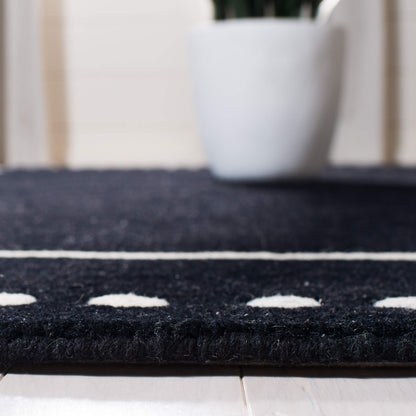 SAFAVIEH Bella Collection Accent Rug - 2' x 3', Black & Ivory, Handmade Dotted Border Wool, Ideal for High Traffic Areas in Entryway, Living Room, Bedroom (BEL151E)