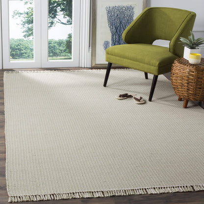SAFAVIEH Montauk Collection Area Rug - 6' x 9', Ivory & Green, Handmade Flat Weave Boho Farmhouse Cotton Tassel Fringe, Ideal for High Traffic Areas in Living Room, Bedroom (MTK340G)