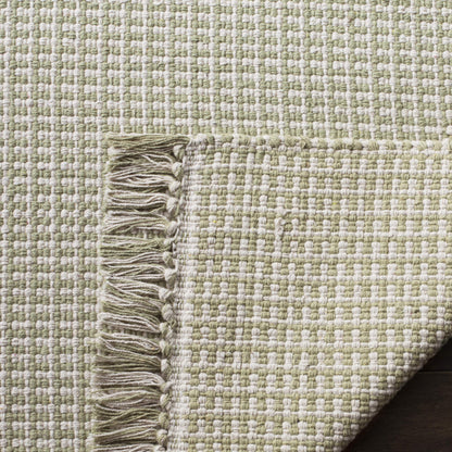 SAFAVIEH Montauk Collection Area Rug - 6' x 9', Ivory & Green, Handmade Flat Weave Boho Farmhouse Cotton Tassel Fringe, Ideal for High Traffic Areas in Living Room, Bedroom (MTK340G)